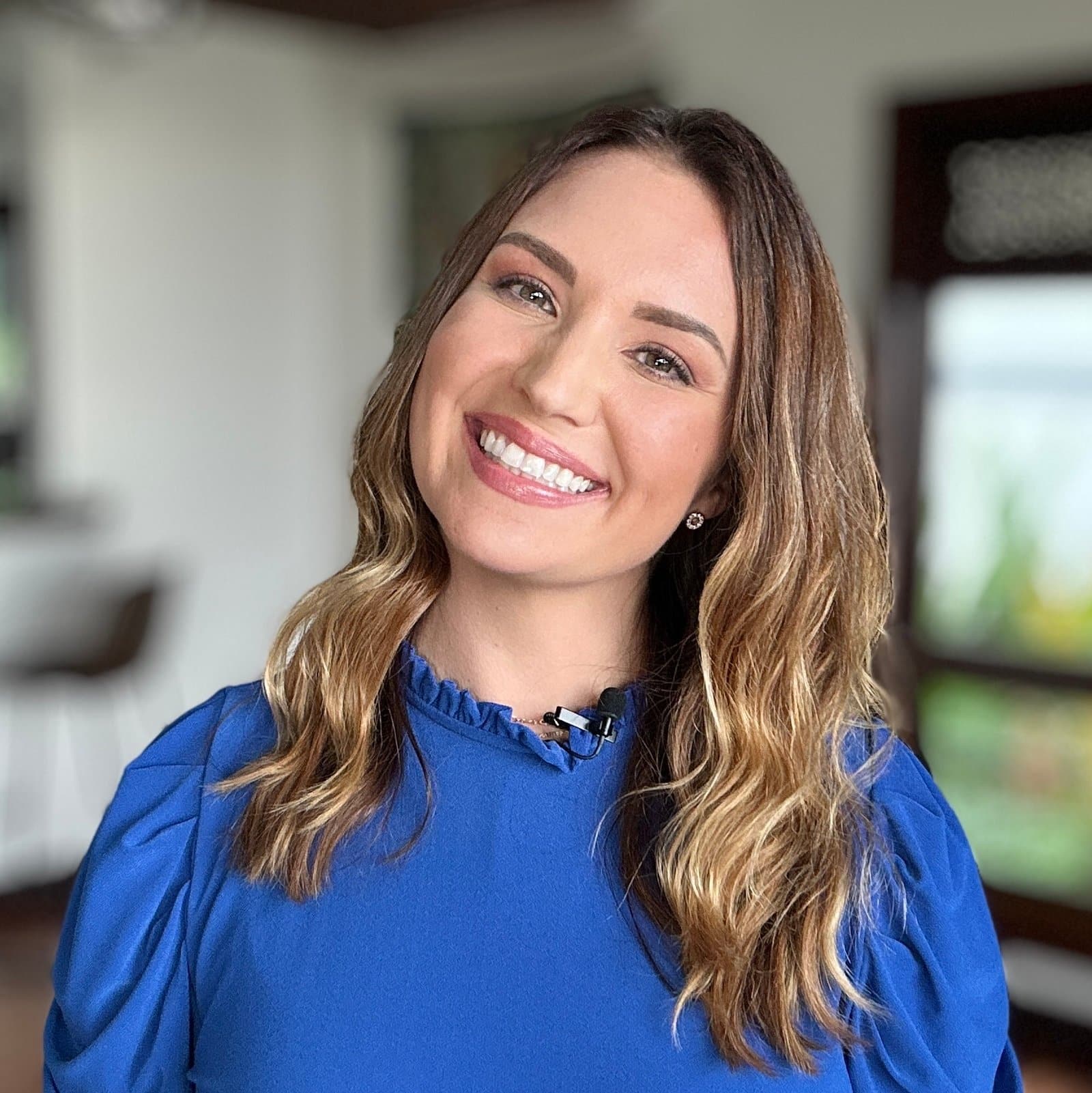 Mandy McEwen, host of the Your Future Biz podcast, smiling in a studio setting